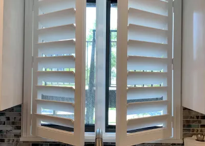 Custom white interior plantation shutters with wide louvers installed in Alabama home - Beach Blinds