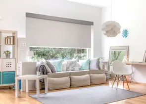 Modern light filtering roller shade installed on large living room window in Alabama home - Beach Blinds window coverings