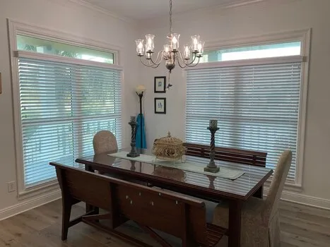 White faux wood horizontal blinds installed on dining room windows in Alabama home - Beach Blinds window coverings