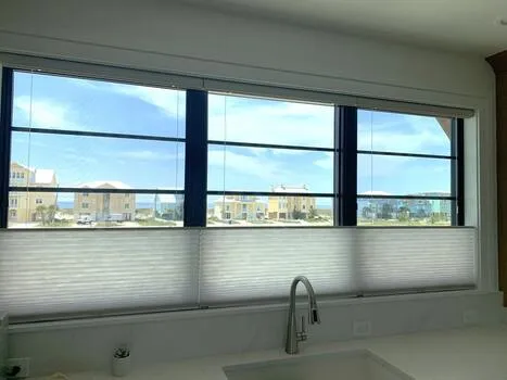 Top down bottom up light filtering cellular honeycomb shades installed on kitchen windows in Alabama beach home - Beach Blinds window coverings