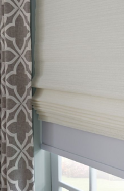 Fabric roman shades with soft folds installed on interior home windows in Alabama - Beach Blinds window treatments